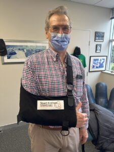Patient after surgery wearing a sling to immobilise their shoulder