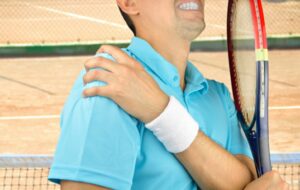 Tennis player suffering from a shoulder dislocation, a common cause of this shoulder injury