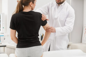Doctor assisting patient with tennis elbow pain